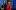 ETC Dead Man_s Cell Phone - Sandy Underwood Two women stand back to back. One has red, shoulder-length hair and is wearing a black v-neck sweater. The woman on the right is wearing a black fedora and a red trench coat. There is an air of mystery and suspicion between them.