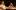 ETC Gem 01 A Black man and a Black woman sit at a table staring outward while having tea.